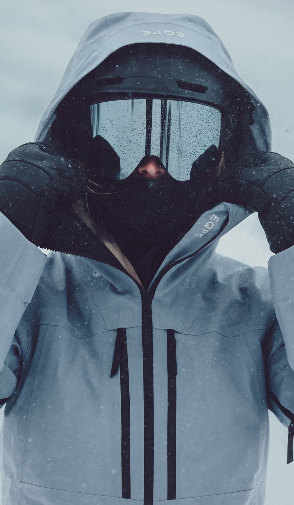 Person in a blue hooded ski jacket